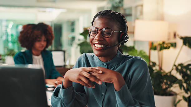 A Virgin Wilderness travel consultant smiling while taking a client enquiry